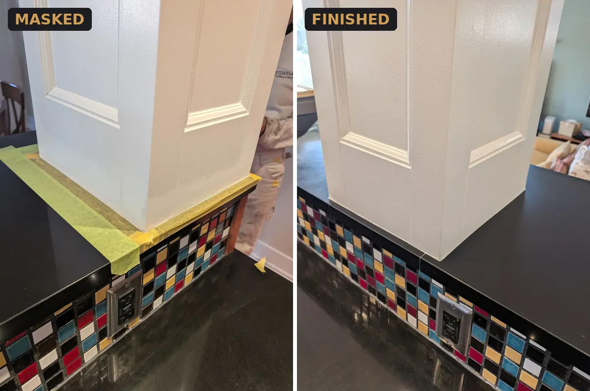 Kitchen island panelling masked against black stone and mosaic tile, then finished in white, in a Hastings-Sunrise home in Vancouver