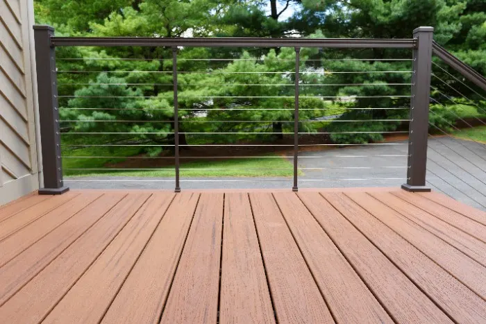 Stainless steel cable railing with aluminum posts and composite boards for the deck.