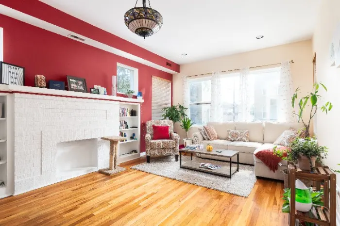 A bold color such as red, orange, pink, and yellow can bring ambiance to a living room.