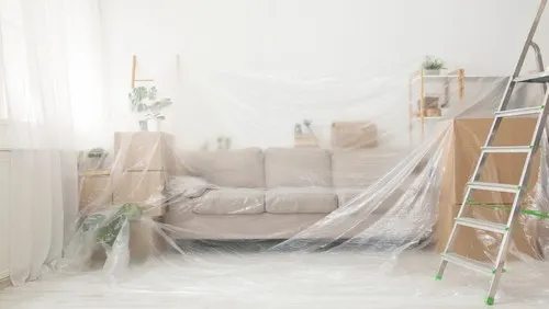 Two layers of protection for this room, one layer of plastic for the furniture and paper for the floor.