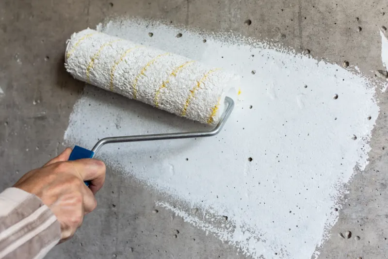 Concrete surfaces will need one coat of primer to seal the porous