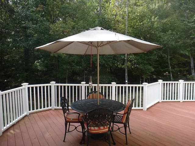 A nice deck with an exterior patio set.