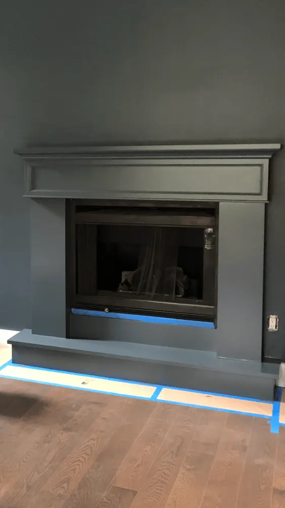 The interior wall and fireplace painted in a black colour.