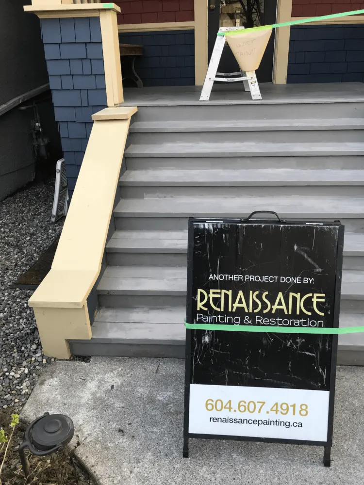 A Renaissance Painting & Carpentry street sign in front of the house.