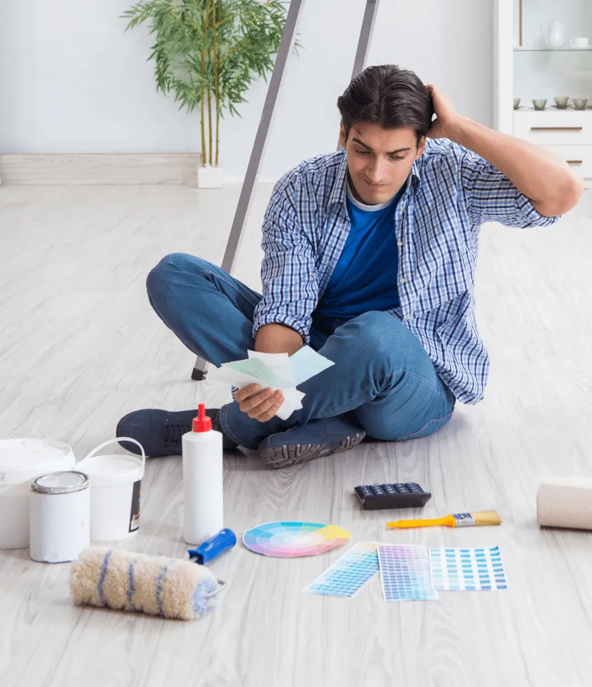 A man is choosing colour to paint the house.