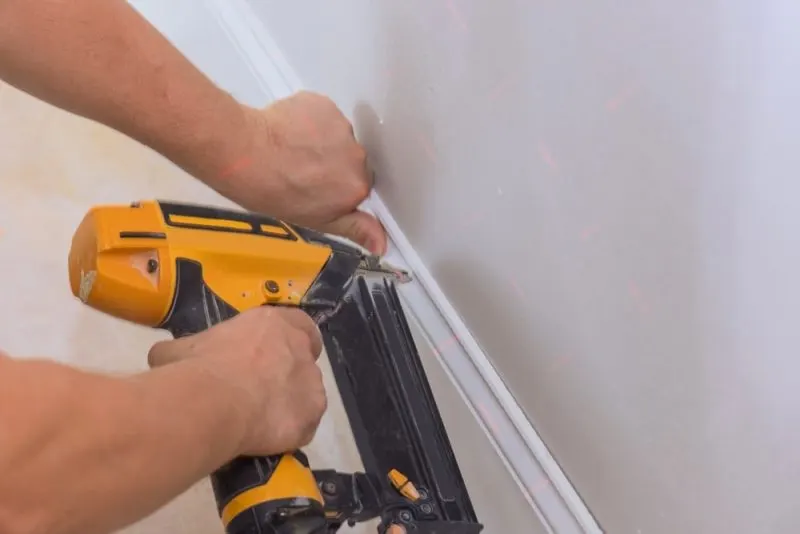 A black and yellow nail gun