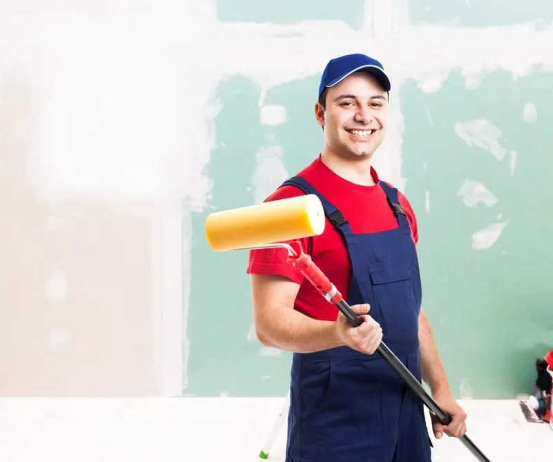 A happy painter with a paint roller.