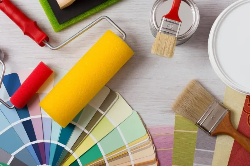 A painting kit with color chips on a floor.