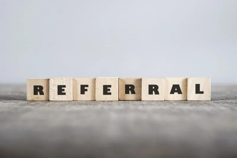 A referral sign made of wooden cubes.