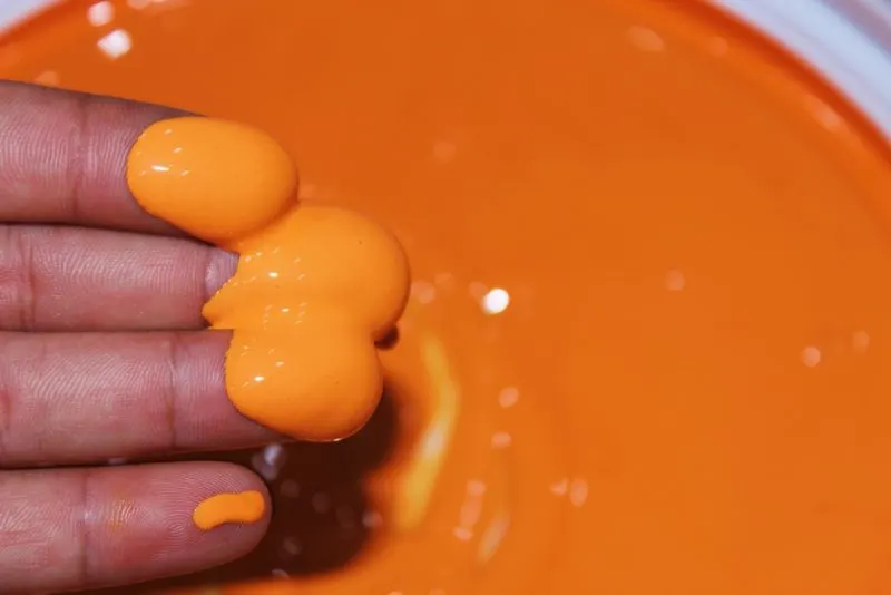 A man touched orange paint.