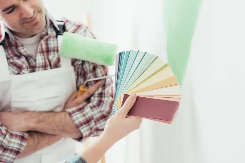 two painters are Choosing the Perfect Paint Color