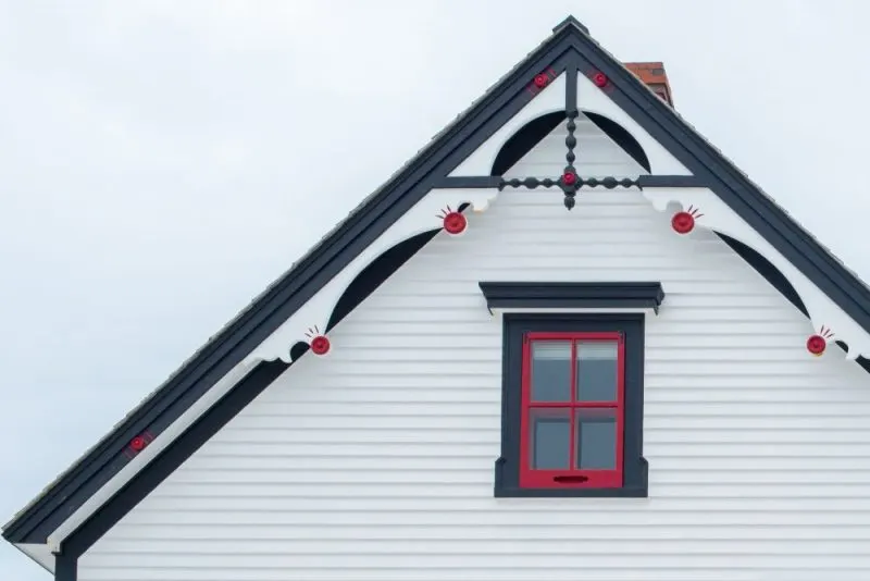 A white house with a Norwegian style exterior trim.