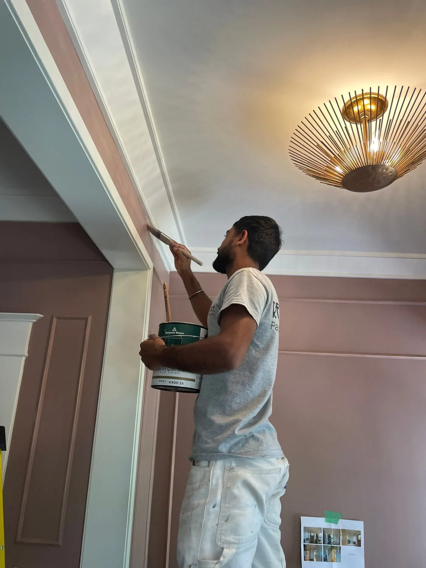 Professional installing crown molding in a living room