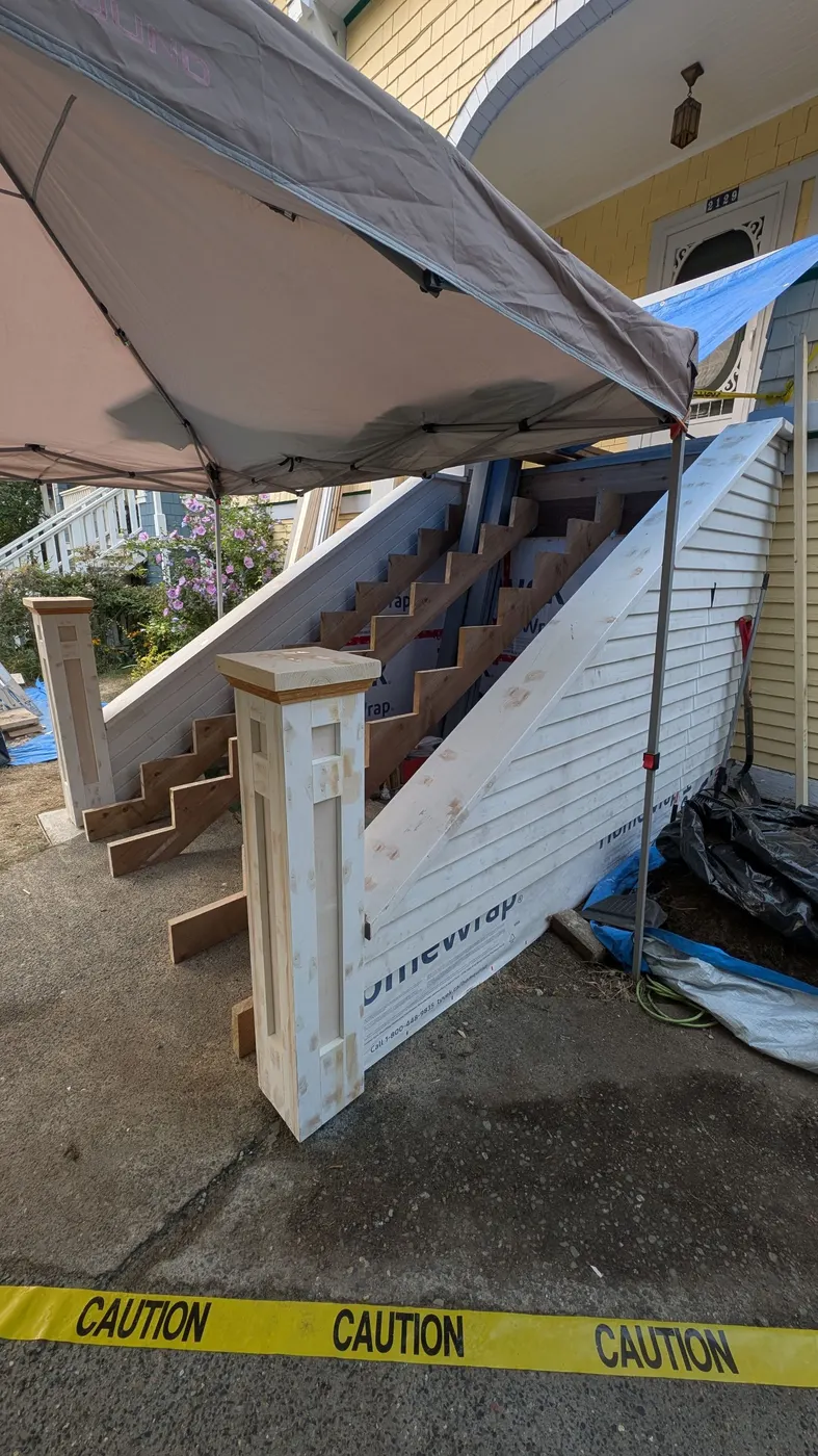 Newly built wood staircase with treads and railings, still unpainted, at a Vancouver character home entrance