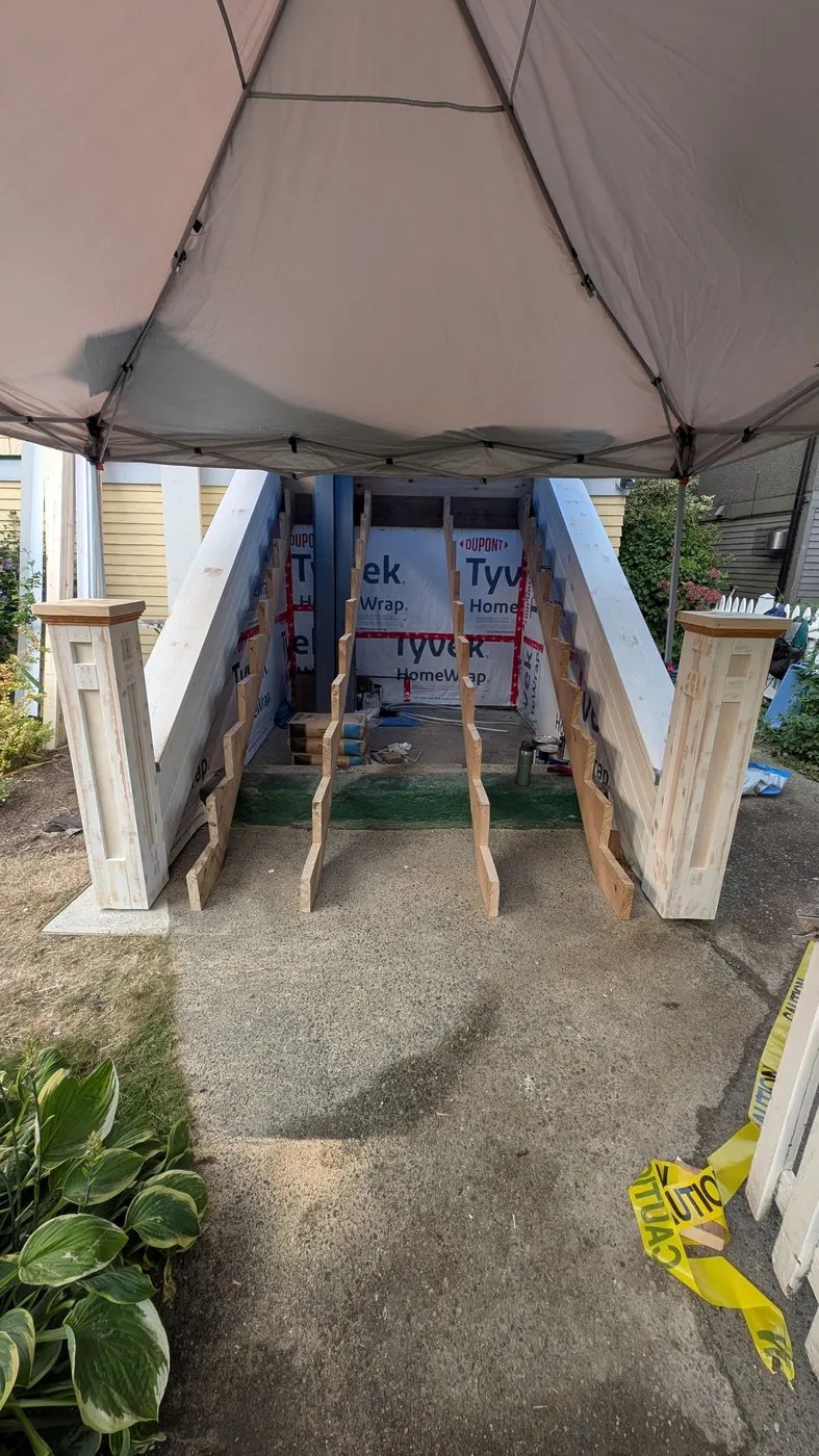 New unfinished wood newel posts and stair stringers installed at a Vancouver home entrance, ready for treads and risers