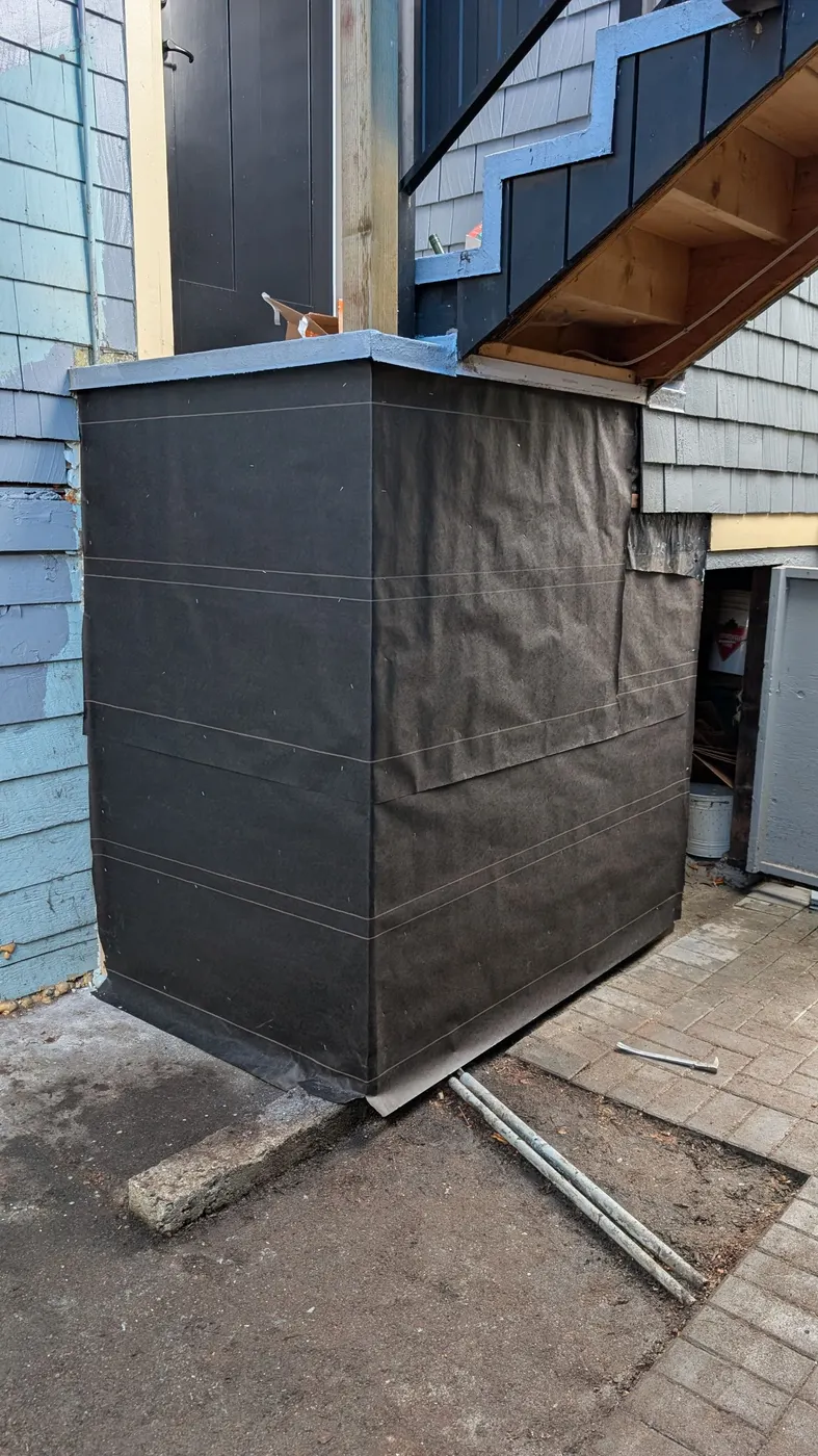 Newly installed and painted gray wood siding on a rebuilt porch column outside a Vancouver, BC home