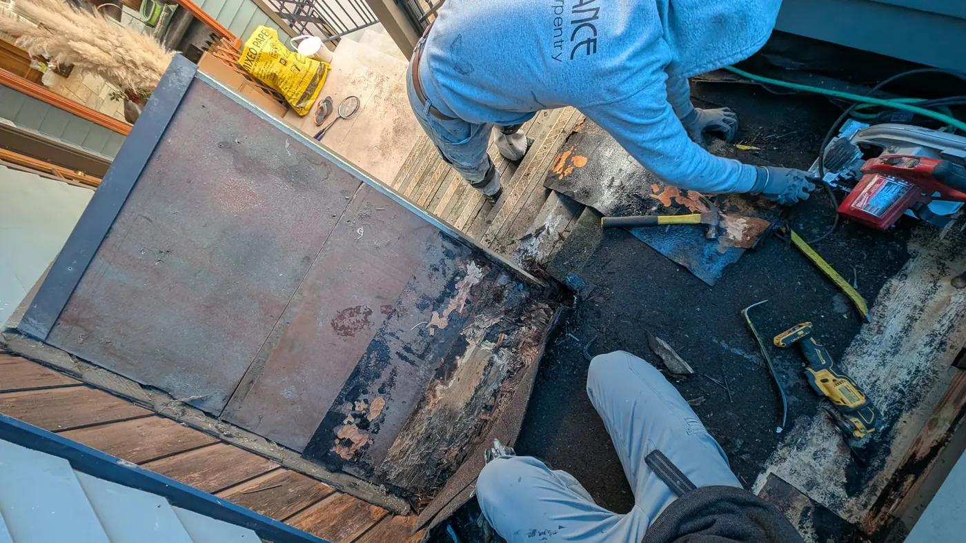 Renaissance Painting carpenter using power tools to repair a deck landing during a renovation in Vancouver, BC.