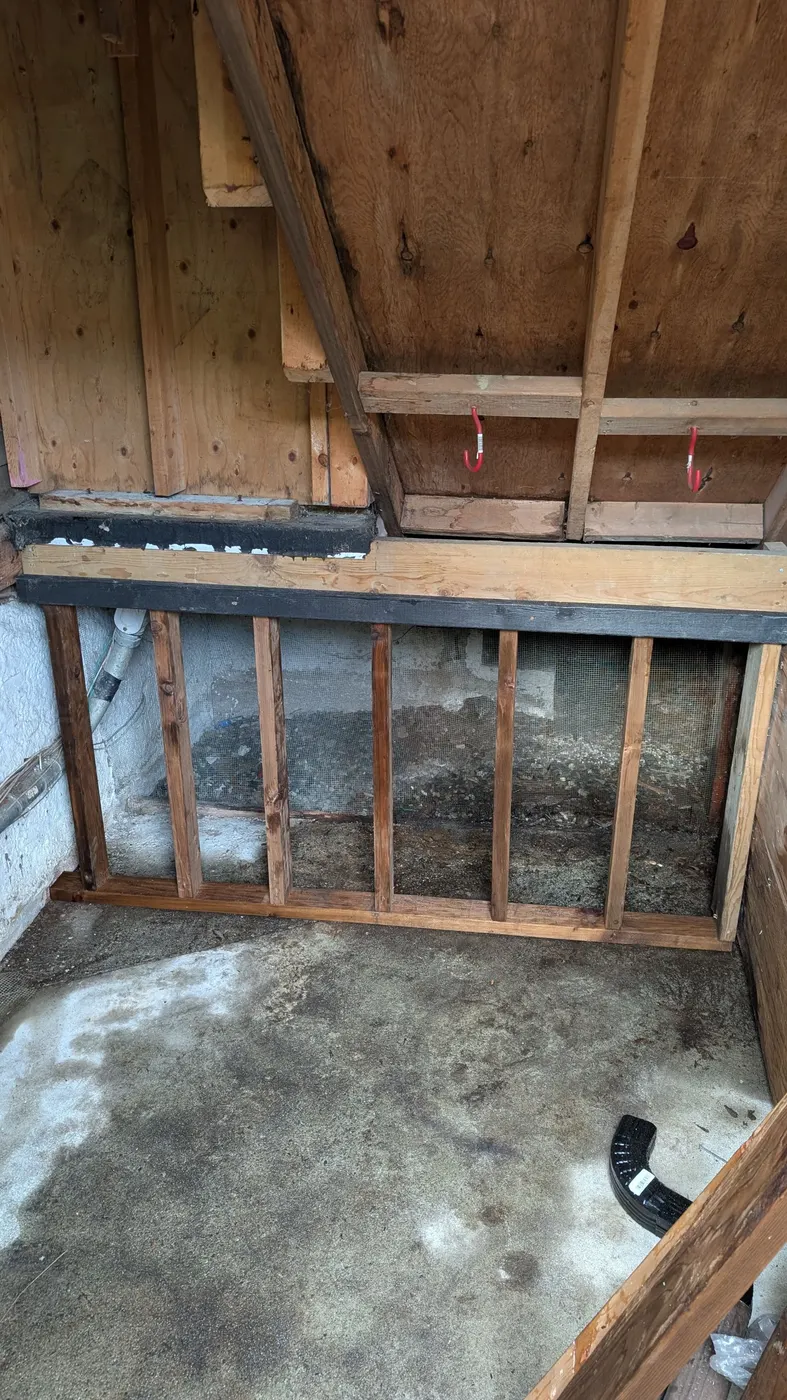 Newly framed wood stud wall built inside a crawlspace as part of a structural carpentry repair in Vancouver, BC.