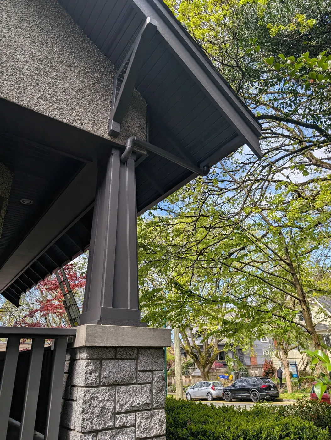 Freshly painted charcoal eave brackets and craftsman porch column on a Vancouver home.