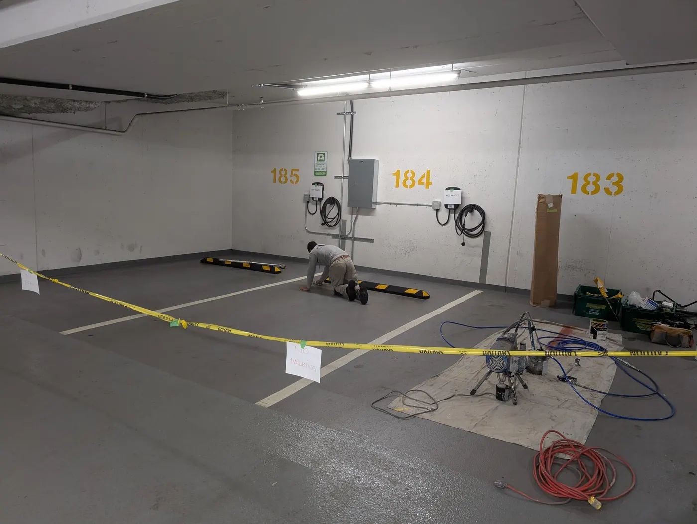 Underground parkade stall in Vancouver, BC taped off and prepped before epoxy floor coating by Renaissance Painting crew.