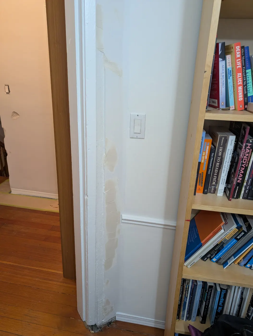 Filled and sanded plaster repairs along a doorway jamb and wall, ready for painting in a Vancouver, BC home.