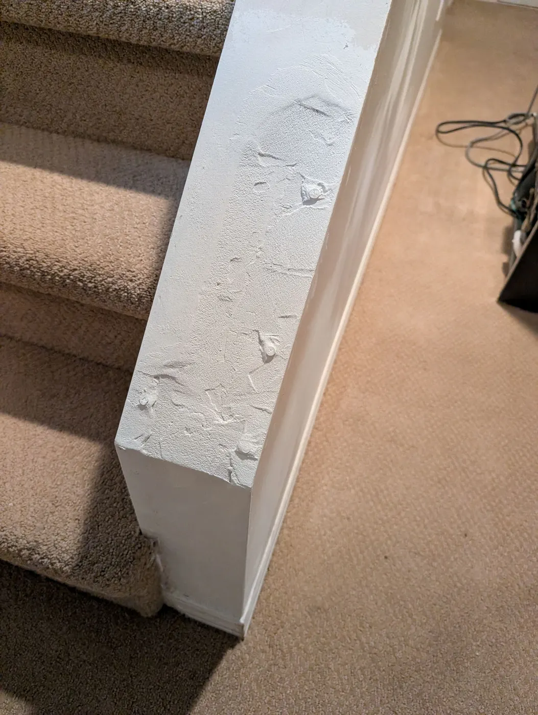 Freshly painted stair newel post with a smooth white finish in a Vancouver, BC home