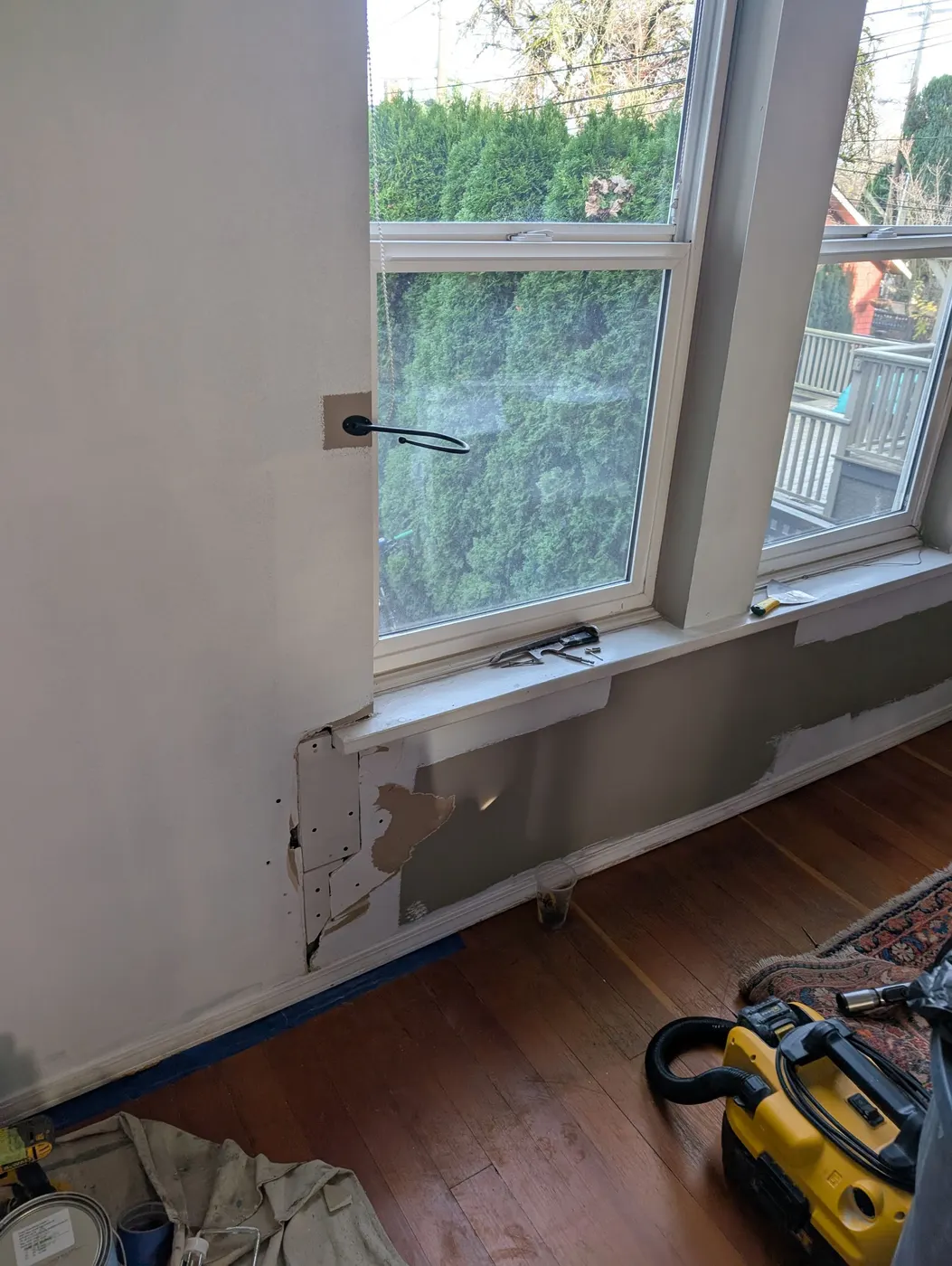 Drywall and window trim repair in progress below a living room window in a Vancouver, BC home