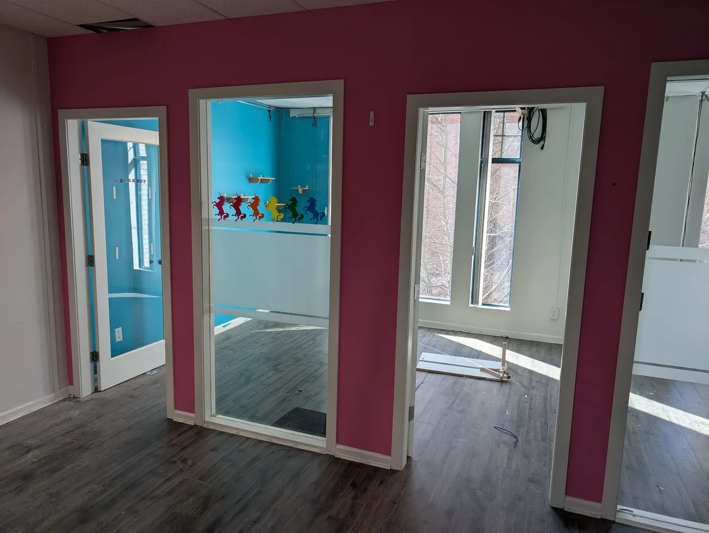 Newly painted pink hallway with glass doorways in a Vancouver interior renovation project