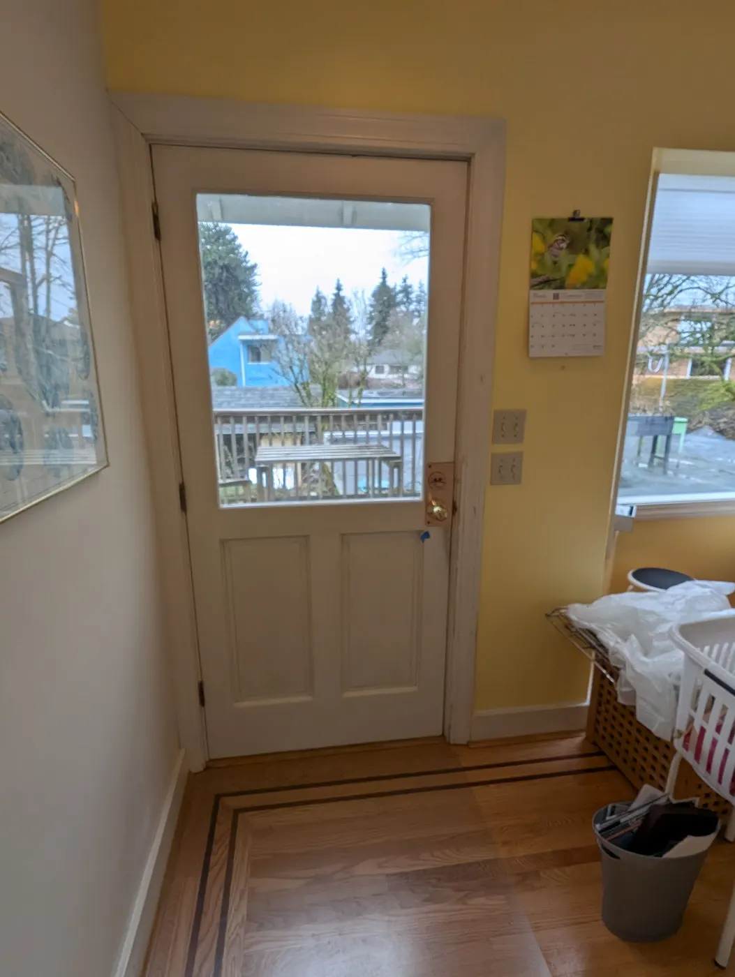 Newly painted white back door with glass panel in a Vancouver character home
