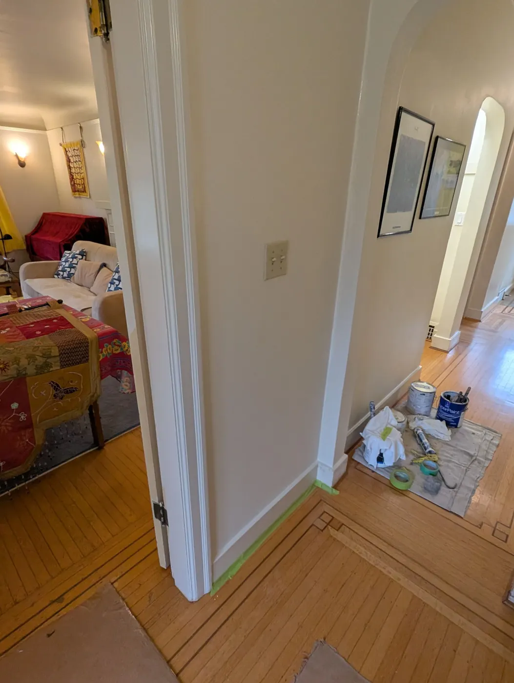 Hallway prepped with painter's tape and supplies during a Vancouver home interior repaint
