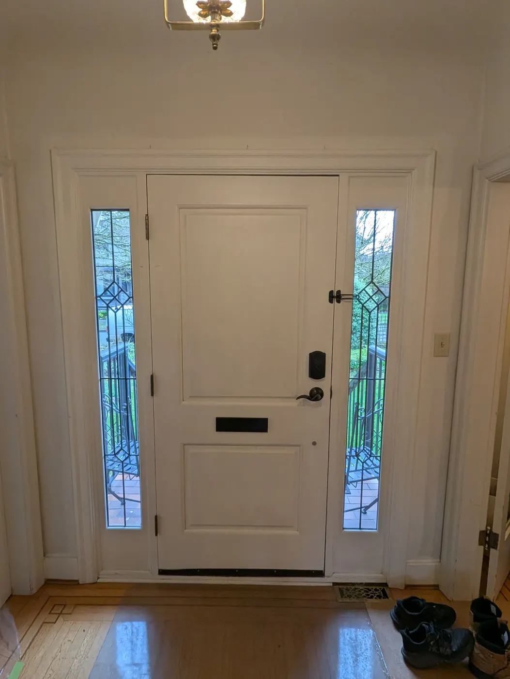 Freshly painted white front door with leaded glass sidelights on a Vancouver home