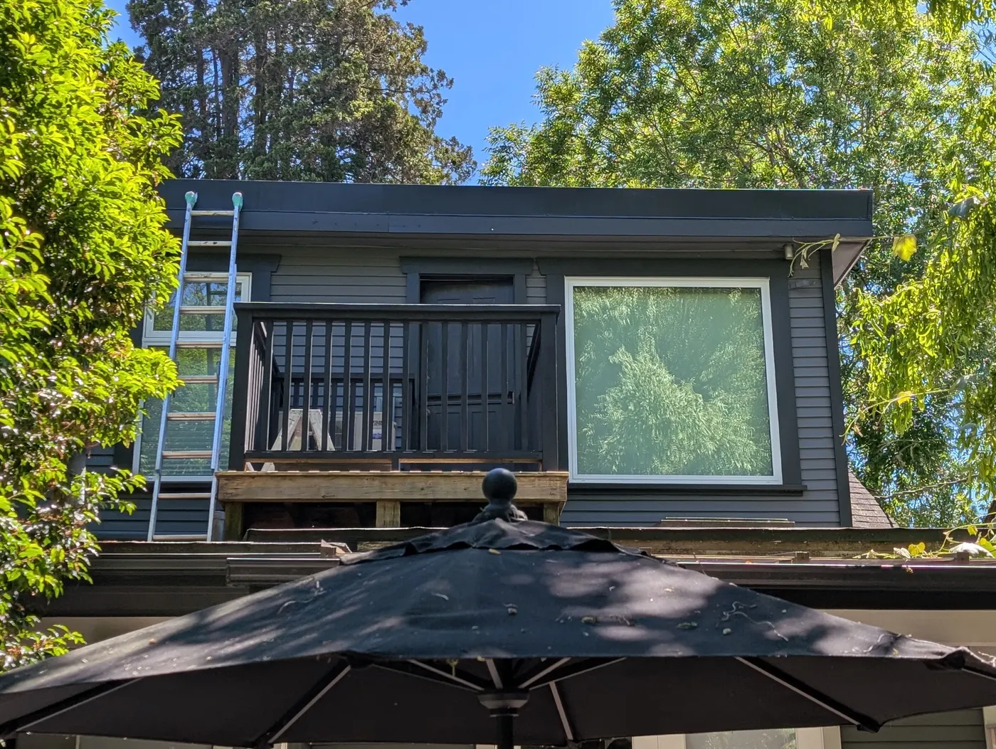 Freshly painted charcoal exterior of a Vancouver, BC duplex with new dark trim and siding