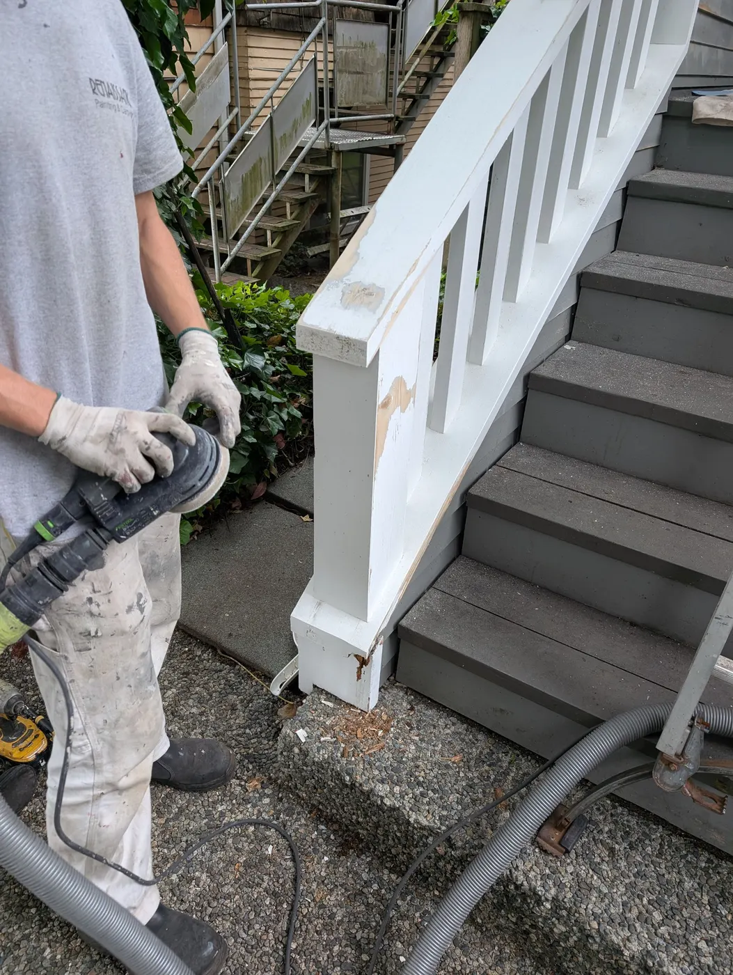 Renaissance Painting crew member preparing tools before exterior painting work on a Vancouver duplex