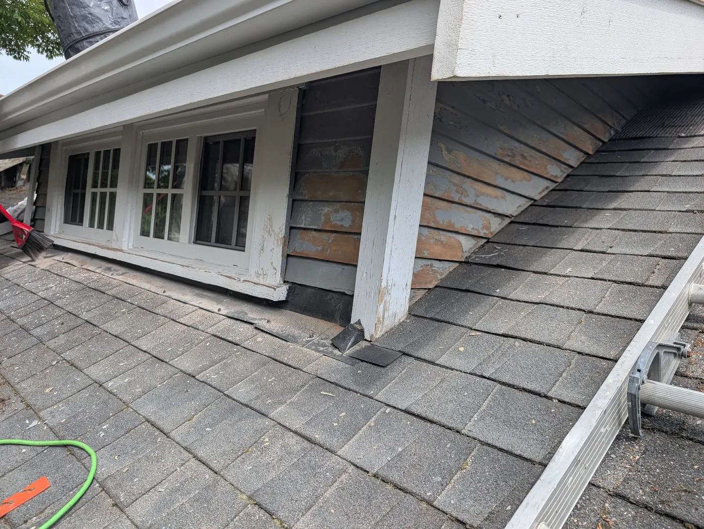 Peeling paint and weathered wood siding on a Vancouver duplex exterior before repainting by Renaissance Painting