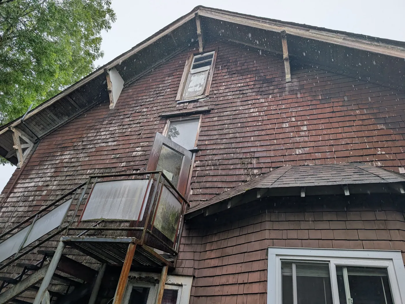 Weathered cedar shingle siding and trim on a Vancouver, BC duplex before exterior restoration