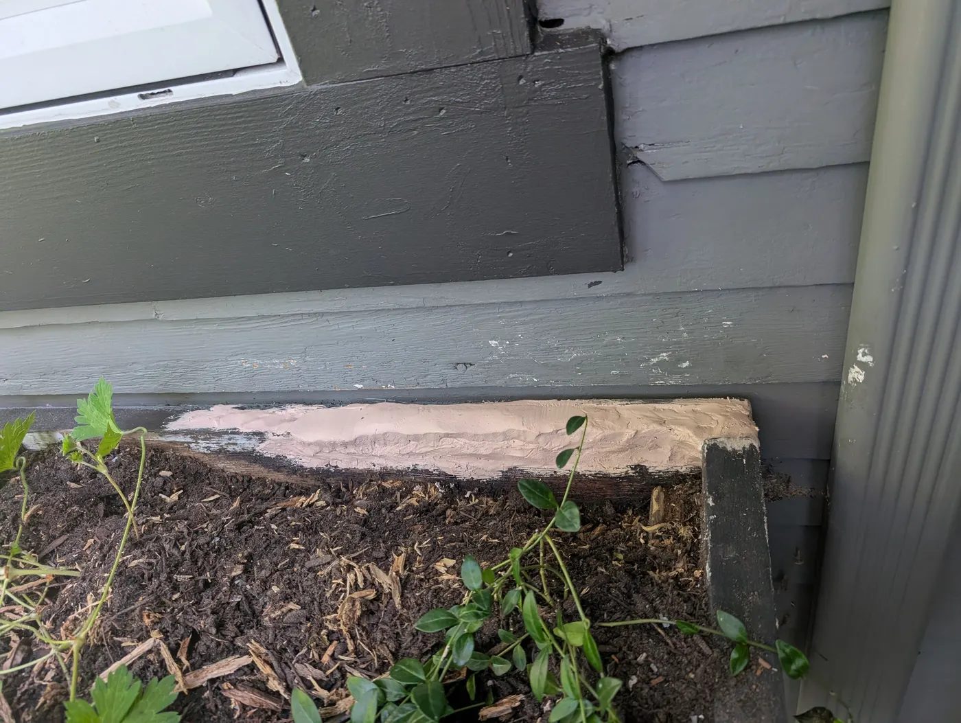 Wood filler repair on exterior trim before final painting on a Vancouver, BC duplex