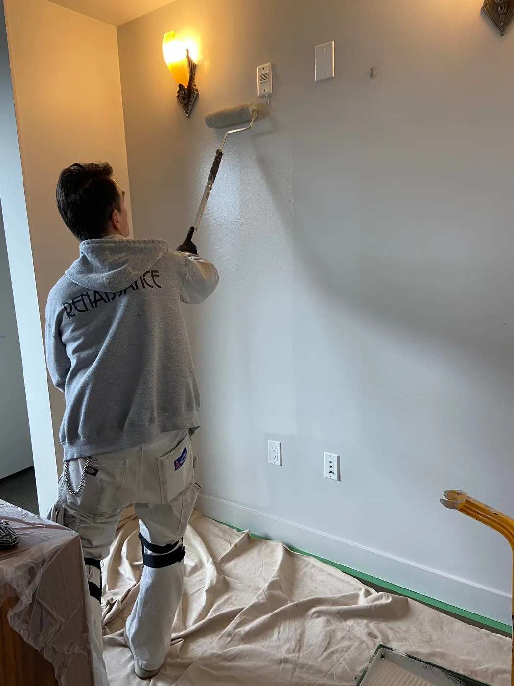 Renaissance Painting applies a fresh coat to an alcove wall with an extension pole roller in a Vancouver, BC home.
