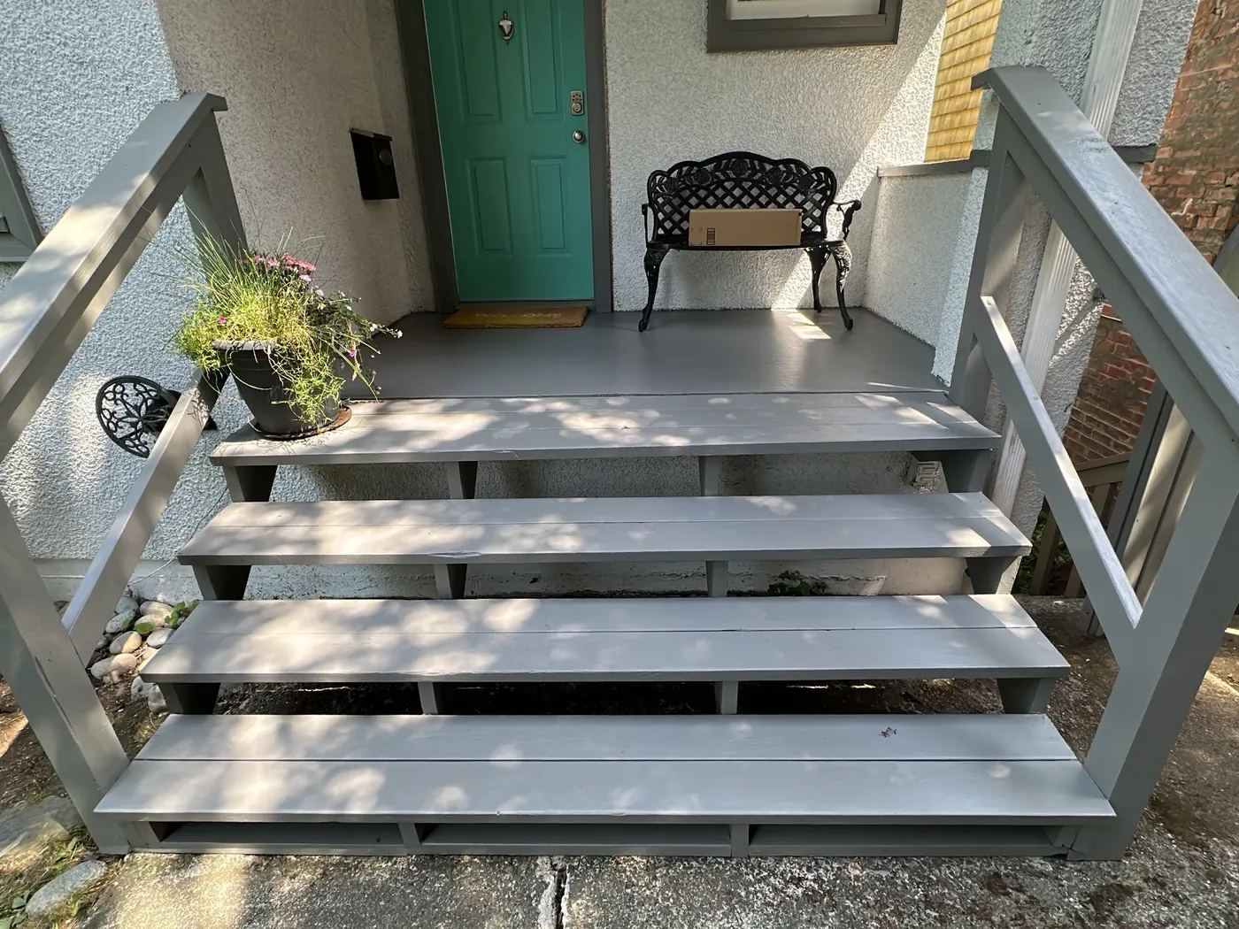 Freshly painted grey front porch steps and railing in Vancouver, BC
