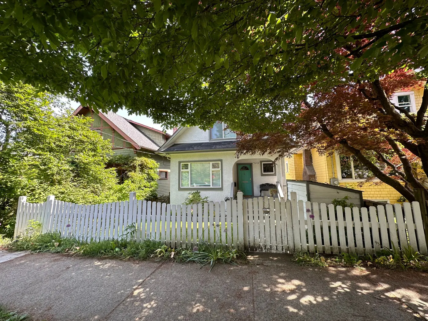 Vancouver character home with an aged white picket fence before exterior painting