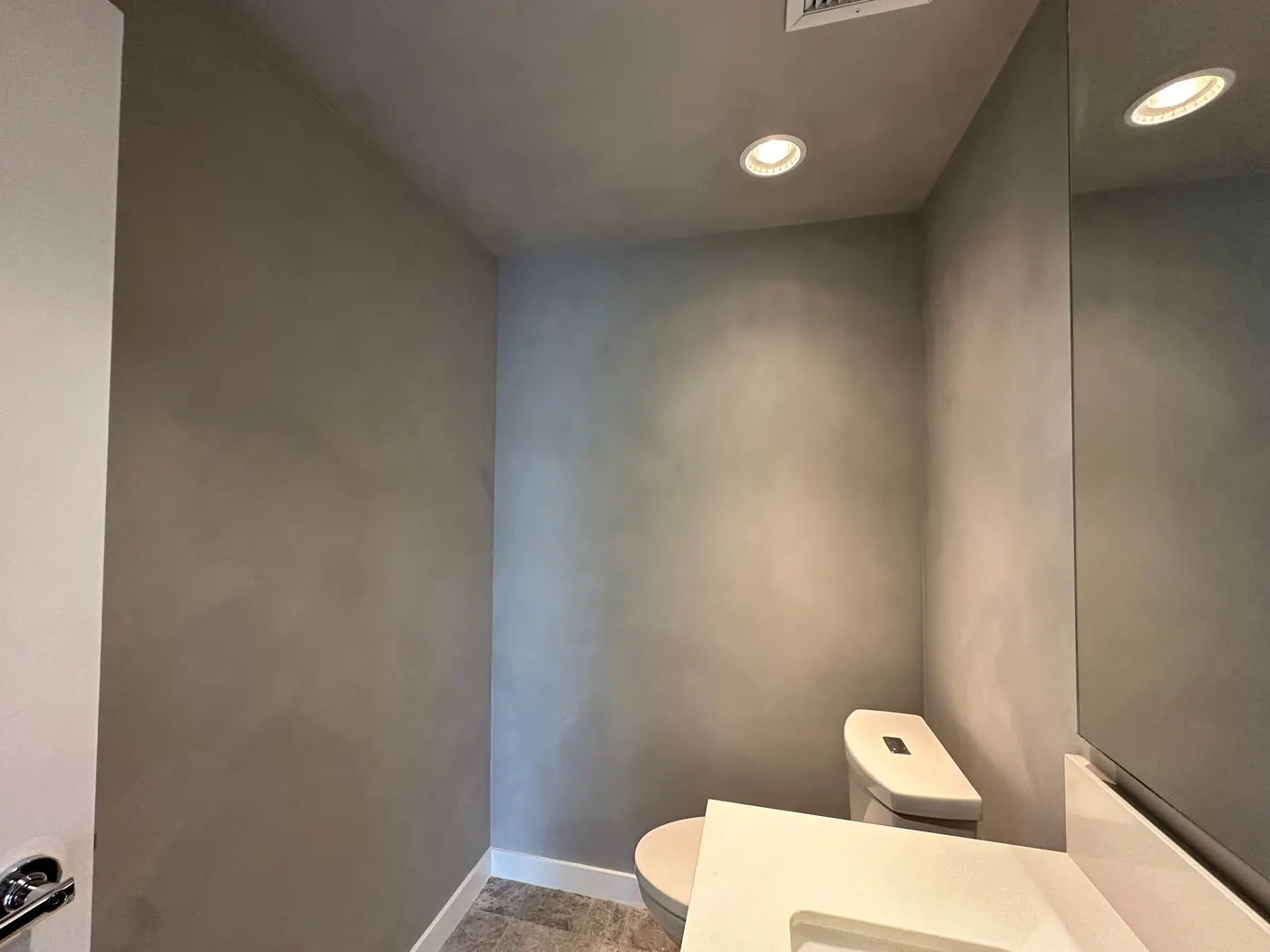 Completed powder room with textured grey Venetian plaster walls in a Vancouver, BC condo.