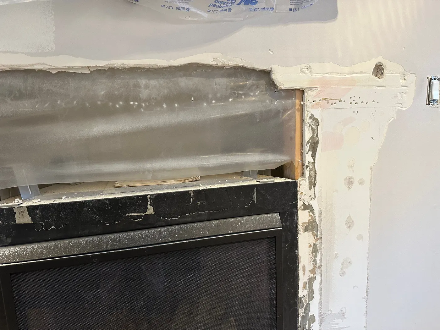 Carpentry and drywall repair around a fireplace surround in a Vancouver home renovation.