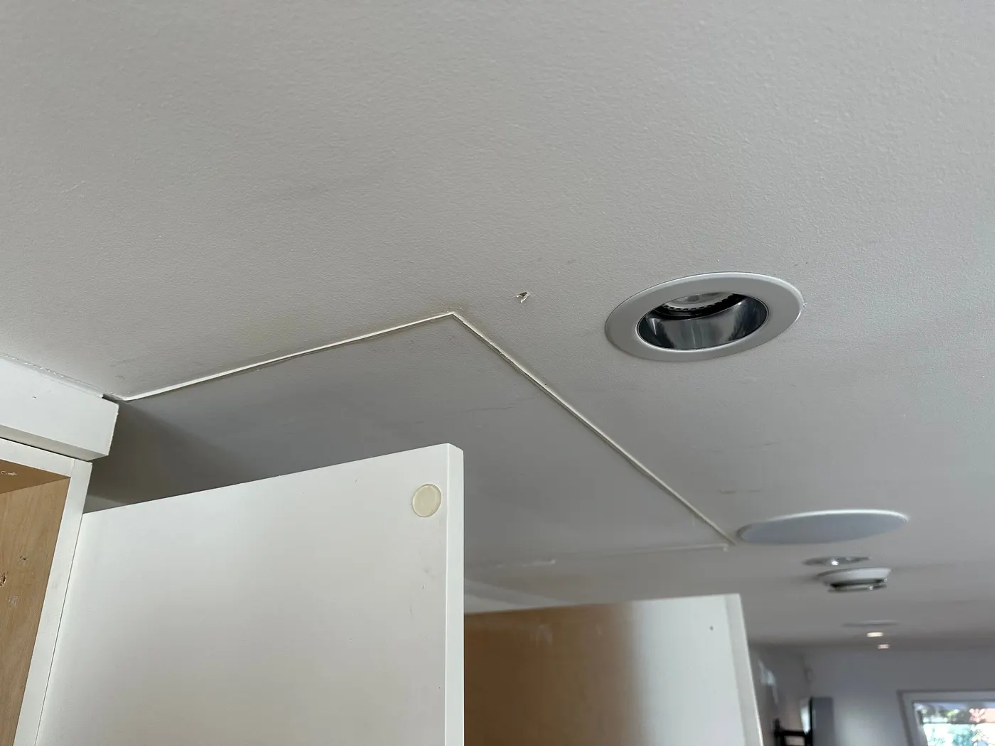 Drywall patch repairs along a staircase wall in a Vancouver, BC renovation project.