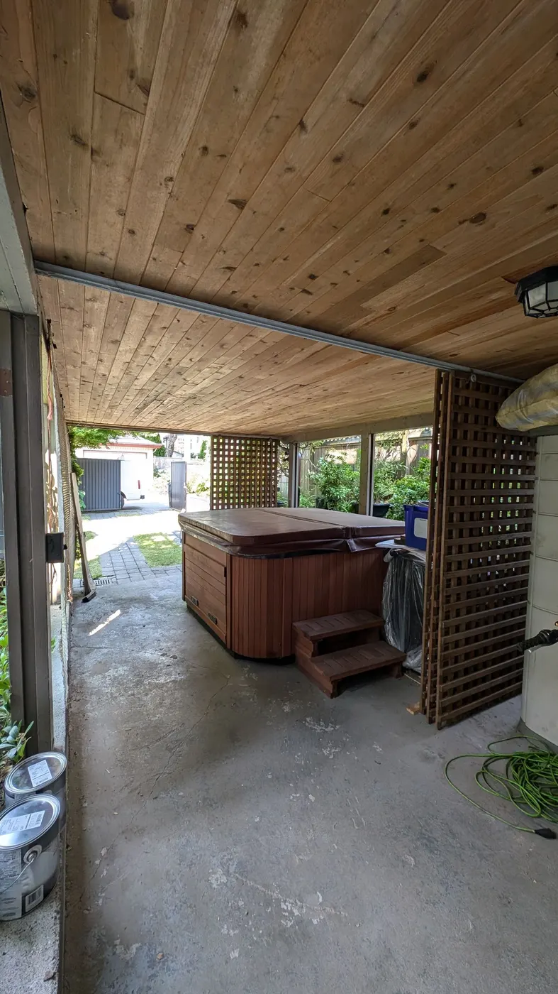 Repaired cedar tongue-and-groove ceiling above a covered patio on a Vancouver, BC home