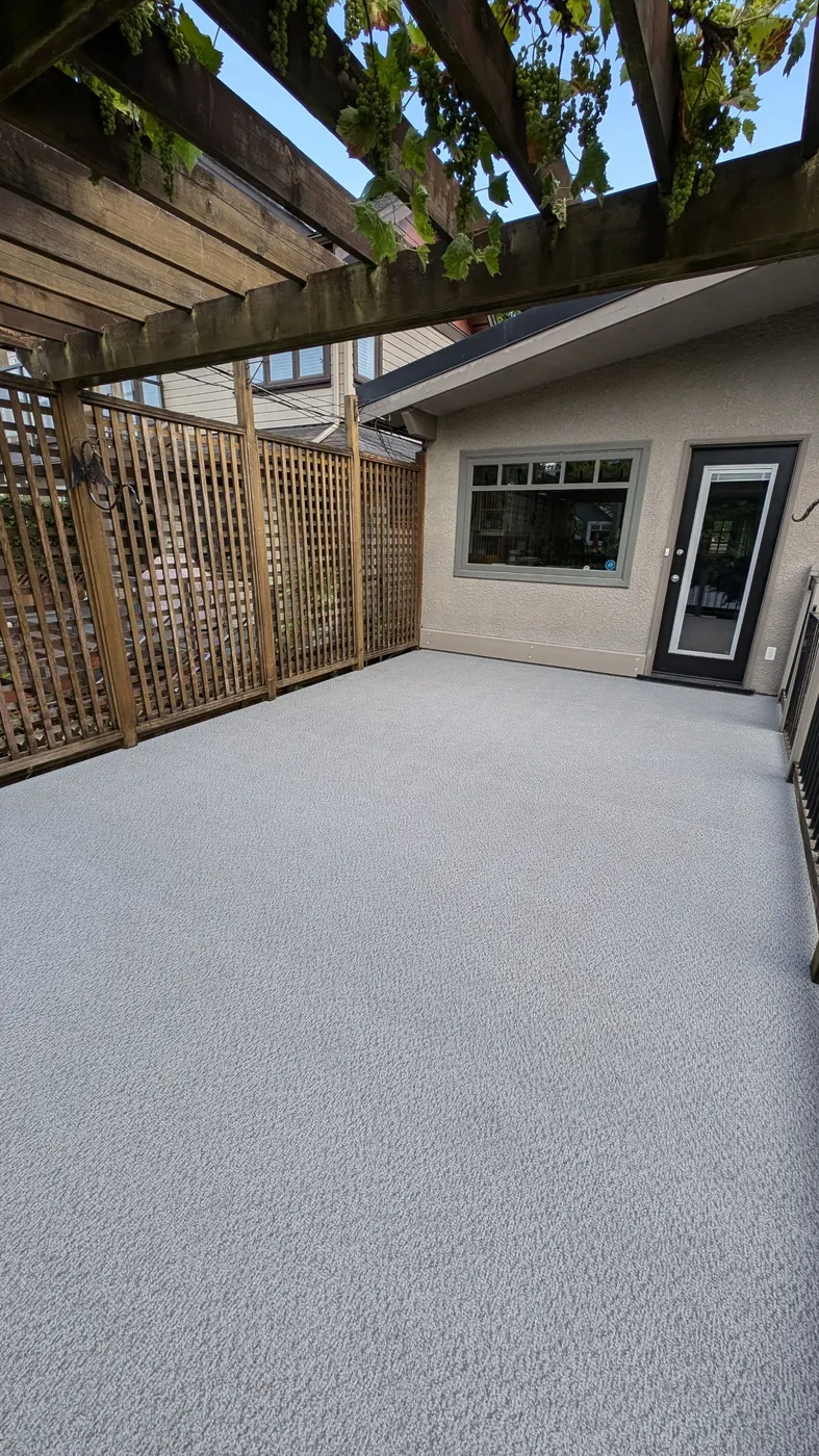 Completed vinyl deck resurfacing on a Vancouver, BC rooftop deck at evening light