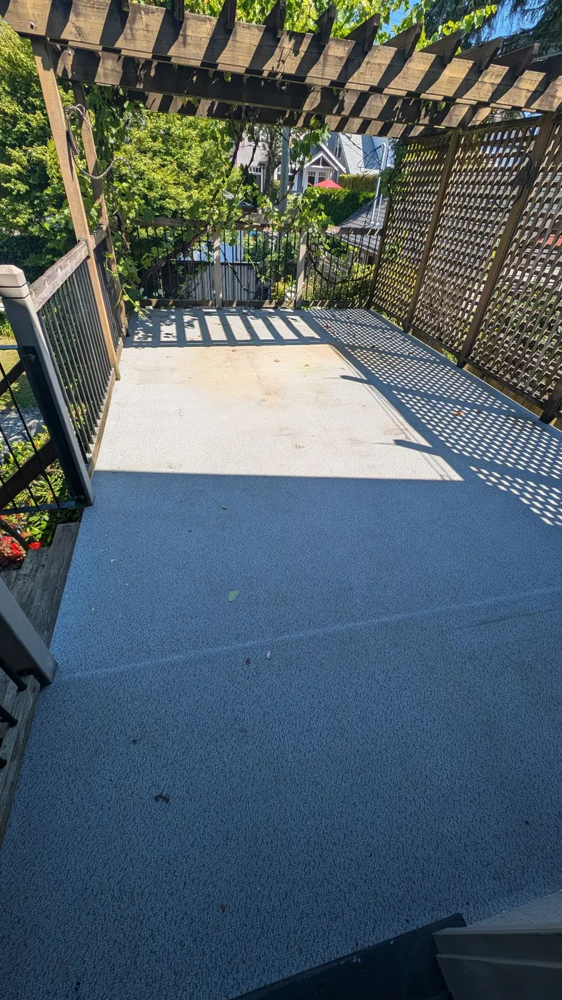 Weathered vinyl deck membrane before resurfacing on a Vancouver, BC upper deck by Renaissance Painting