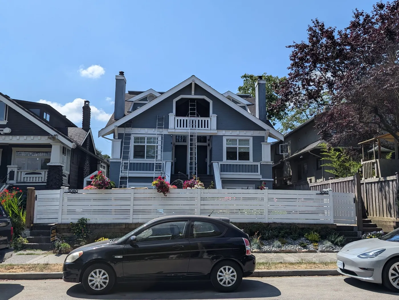 Craftsman-style home on Point Grey Rd in Vancouver, BC before exterior repaint, with painting ladders set up along the front facade