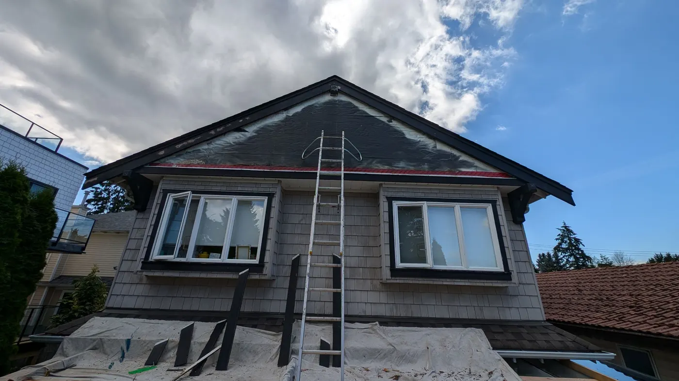 New fascia boards staged for installation beneath a Vancouver, BC home's roof gable