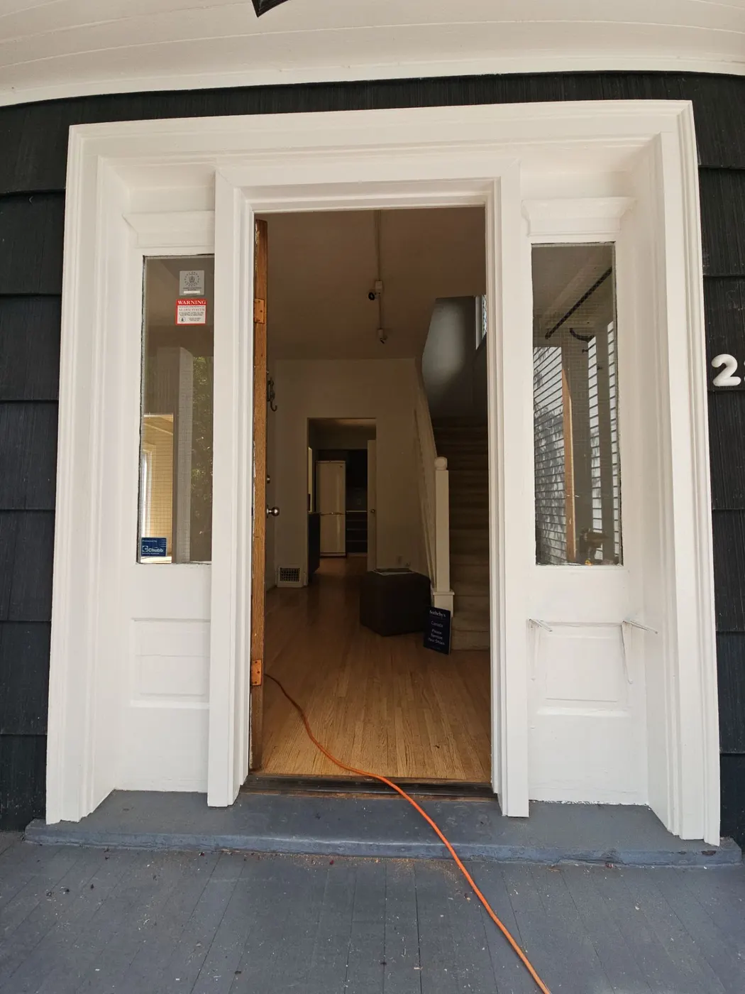 Freshly painted front entry door and white trim on a Vancouver character home by Renaissance Painting.