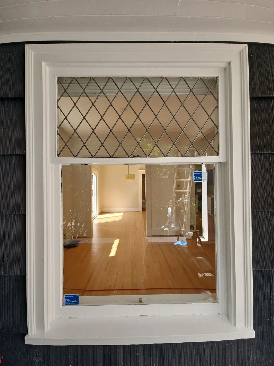 Freshly painted white window trim and navy shingle siding on a Vancouver home exterior.