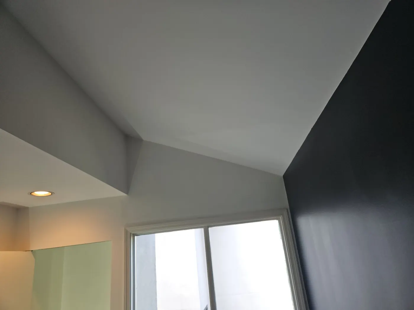 Freshly painted vaulted ceiling corners with fire sprinkler head in a Vancouver, BC home by Renaissance Painting